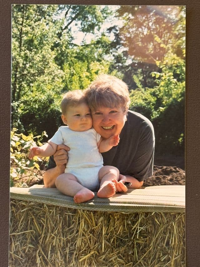Hazel with baby Rowan on a bale of hay
